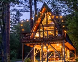 Designer A-Frame Treehouse with hot tub on river